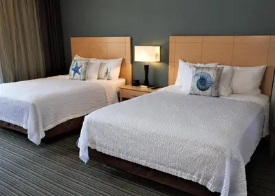 a hotel room with two beds with white sheets at Inn by the Sea, La Jolla in San Diego