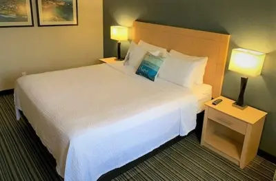 a hotel room with a large bed and two lamps at Inn by the Sea, La Jolla in San Diego