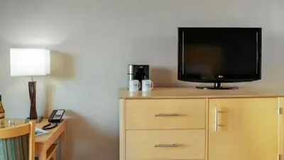 a tv on top of a dresser in a hotel room at Inn by the Sea, La Jolla in San Diego