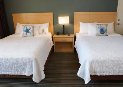 a hotel room with two beds with white sheets at Inn by the Sea, La Jolla in San Diego
