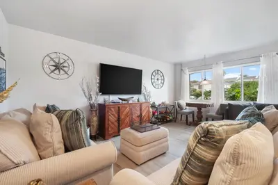 a living room with couches and a flat screen tv at Pacific Beach Cottage in San Diego