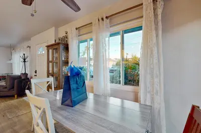 a dining room with a table and a large window at Pacific Beach Cottage in San Diego