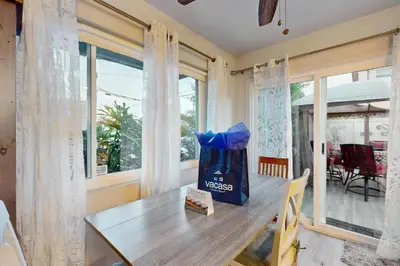 a dining room with a table and a window at Pacific Beach Cottage in San Diego