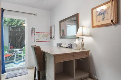 a home office with a desk and a mirror at Pacific Beach Cottage in San Diego
