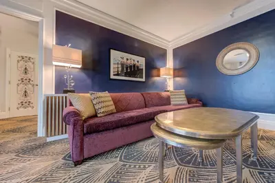 a living room with a purple couch and a table at Inn at the Park in San Diego