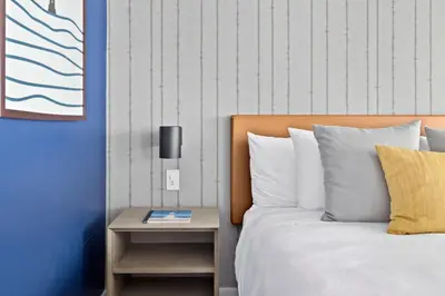 a bedroom with a bed and a nightstand next to a bed at Sea Harbor Hotel - San Diego in San Diego