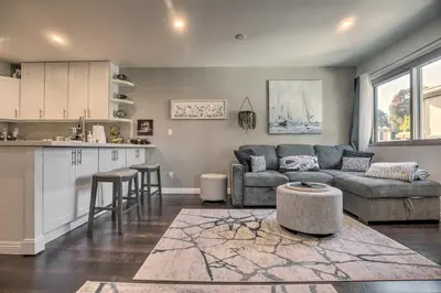a living room with a couch and a kitchen at Contemporary San Diego Gem with Community Pool! in San Diego