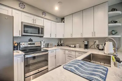 a kitchen with white cabinets and a sink at Contemporary San Diego Gem with Community Pool! in San Diego