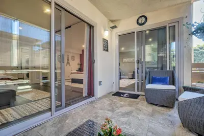 a living room with a clock on the wall at Contemporary San Diego Gem with Community Pool! in San Diego