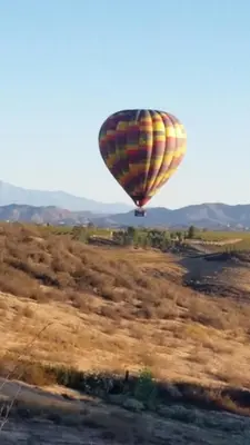 a hot air balloon flying over a field at Sommer Hus-Best value in Southern California Wine Country in Temecula