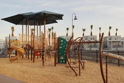a playground with a slide and an umbrella at Sun Outdoors San Diego Bay in Chula Vista