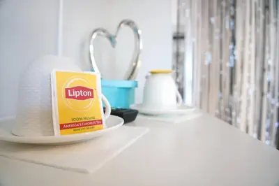 a shelf with a cup of lipton coffee on a table at Spacious Guest Suite Amazing Location in San Diego