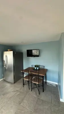 a kitchen with a table and a stainless steel refrigerator at Big Studio with Ocean View max 6 sleepers in San Diego