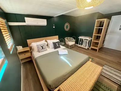 a bedroom with a bed and a green wall at COZY Studio in Downtown San Diego in San Diego