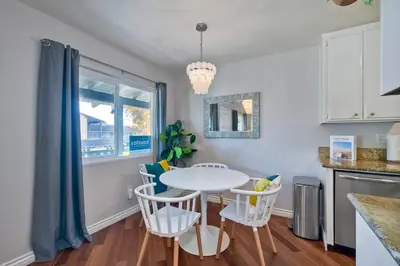 a kitchen with a white table and chairs at 90 Walk Score - Steps to Beach & Dining - Reserved Parking in Carlsbad
