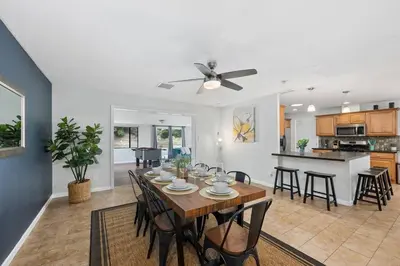 a dining room and kitchen with a table and chairs at 4 BR Home with Game Room! Family Friendly! Centrally Located! in San Diego