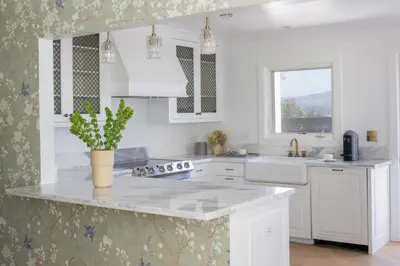 a white kitchen with a sink and a counter top at The Inn at Rancho Santa Fe in Rancho Santa Fe