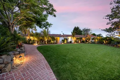 a backyard with a brick walkway and a lawn at The Inn at Rancho Santa Fe in Rancho Santa Fe