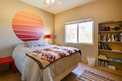 a bedroom with a large bed and a book shelf at Borrego Springs Stargazing Home with Mtn Views in Borrego Springs