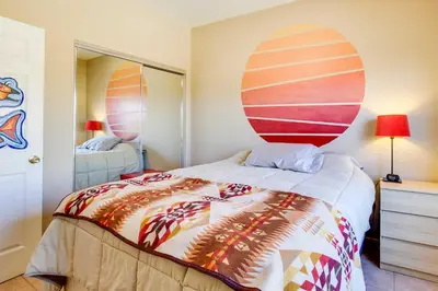 a bedroom with a bed with a surfboard on the wall at Borrego Springs Stargazing Home with Mtn Views in Borrego Springs