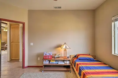 a bedroom with two beds and a table with a lamp at Borrego Springs Stargazing Home with Mtn Views in Borrego Springs