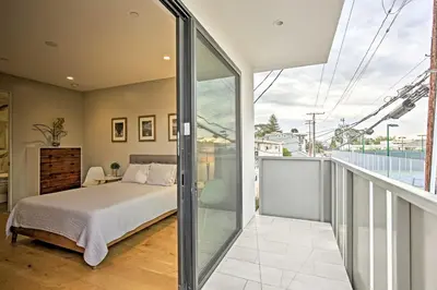 a bedroom with a bed and a balcony at Chic Coronado Retreat with Patio and 4 Cruiser Bikes! in San Diego