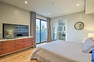 a bedroom with a large bed and a television at Chic Coronado Retreat with Patio and 4 Cruiser Bikes! in San Diego