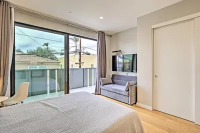 a bedroom with a bed and a chair and a window at Chic Coronado Retreat with Patio and 4 Cruiser Bikes! in San Diego