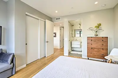 a bedroom with a bed and a couch and a bathroom at Chic Coronado Retreat with Patio and 4 Cruiser Bikes! in San Diego