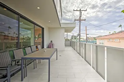 a patio with a table and chairs on a balcony at Chic Coronado Retreat with Patio and 4 Cruiser Bikes! in San Diego