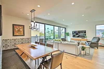 a dining room and living room with a table and chairs at Chic Coronado Retreat with Patio and 4 Cruiser Bikes! in San Diego