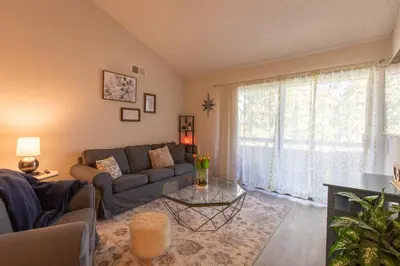 a living room with a couch and a table at Huge Oceanside Private 2BR Apartment-Pool-Gym-Spa in Oceanside