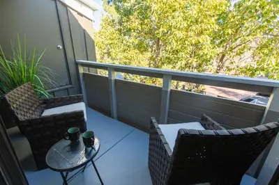 a balcony with two chairs and a table and a table and chairs at Huge Oceanside Private 2BR Apartment-Pool-Gym-Spa in Oceanside
