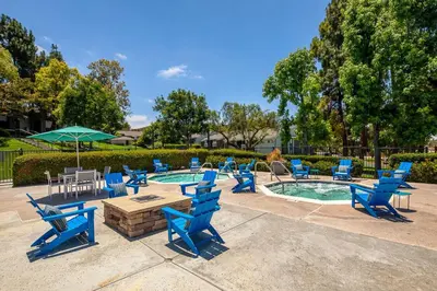 a group of blue chairs around a swimming pool at Huge Oceanside Private 2BR Apartment-Pool-Gym-Spa in Oceanside