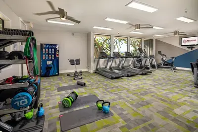 a gym with several treadmills and exercise bikes in it at Huge Oceanside Private 2BR Apartment-Pool-Gym-Spa in Oceanside