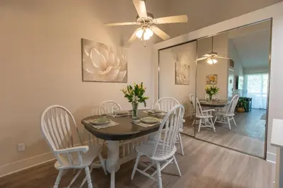 a dining room with a table and chairs and a ceiling fan at Huge Oceanside Private 2BR Apartment-Pool-Gym-Spa in Oceanside