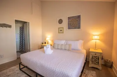 a bedroom with a white bed with two lamps at Huge Oceanside Private 2BR Apartment-Pool-Gym-Spa in Oceanside