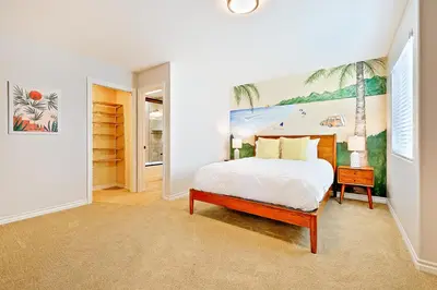 a bedroom with a bed and a painting on the wall at Crown Point Views Home in San Diego