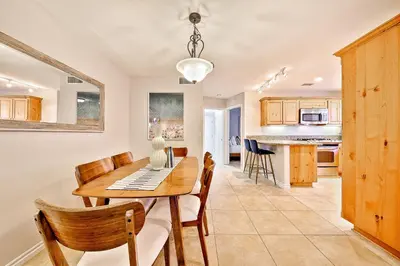 a dining room and kitchen with a table and chairs at Crown Point Views Home in San Diego