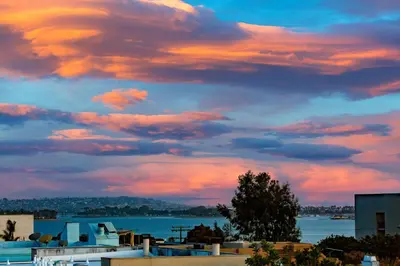 a cloudy sky over the water and a city at Crown Point Views Home in San Diego