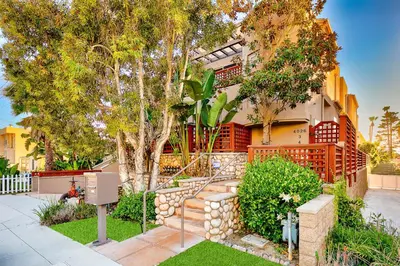 a house with a staircase in front of a yard at Crown Point Views Home in San Diego