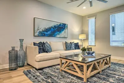 a living room with a couch and a coffee table at Modern Irvine Condo with Pool - 7 Mi to Beach! in Irvine