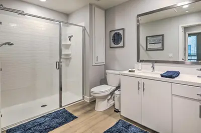 a bathroom with a shower and a toilet and a sink at Modern Irvine Condo with Pool - 7 Mi to Beach! in Irvine