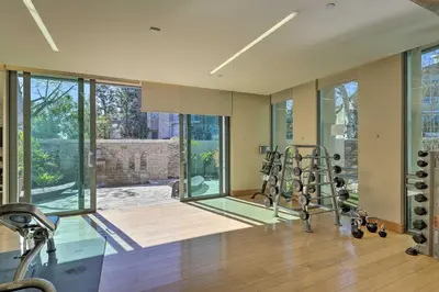 a gym with treadmills and ellipticals in a house at Modern Irvine Condo with Pool - 7 Mi to Beach! in Irvine