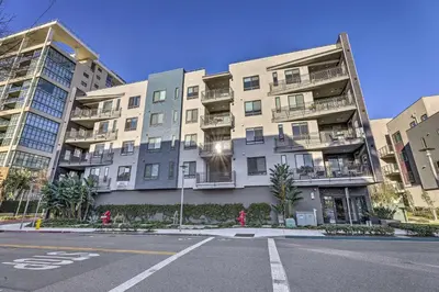 an empty street in front of an apartment building at Modern Irvine Condo with Pool - 7 Mi to Beach! in Irvine