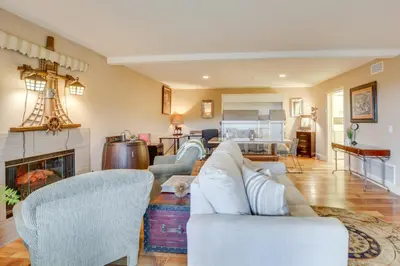 a living room with a couch and a fireplace at Hot Tub and Balcony Rainbow Retreat Near Wineries! in Fallbrook