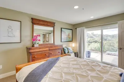 a bedroom with a large bed and a large window at Hot Tub and Balcony Rainbow Retreat Near Wineries! in Fallbrook