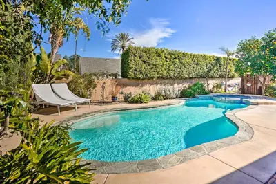 a swimming pool with a chair in a yard at Deluxe Laguna Hills Home with Outdoor Oasis! in Laguna Hills