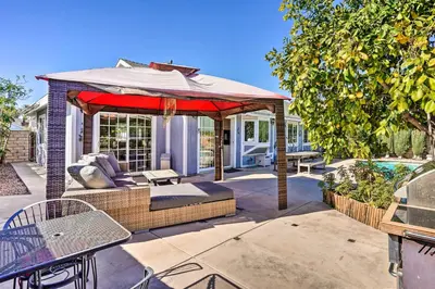 a patio with a table and an umbrella at Deluxe Laguna Hills Home with Outdoor Oasis! in Laguna Hills