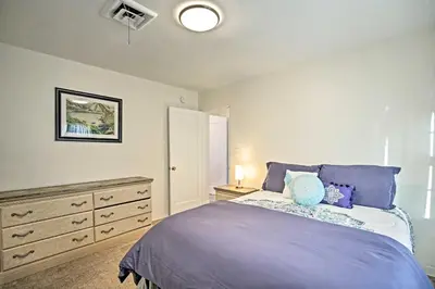 a bedroom with a purple bed and a dresser at Quaint La Mesa Home with Beautiful Sunsets! in La Mesa